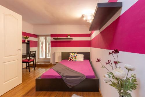a room with a pink and purple accent wall at Buda or Pest in Budapest