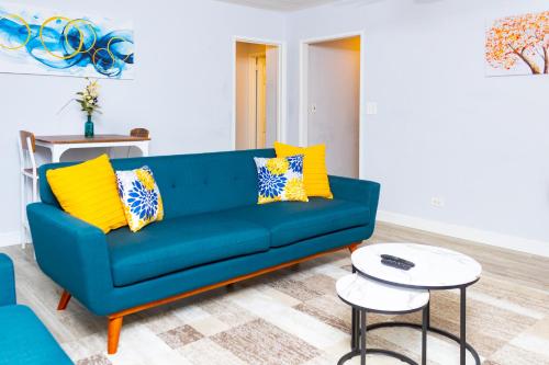 a blue couch with yellow pillows in a living room at Star Oasis 1 Bedroom Condo Downtown Atlanta in Atlanta