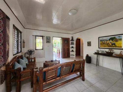a living room with a couch and a table at Palmera Palma Private 2 Bedroom Bungalow in Moalboal