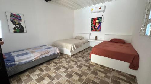 a bedroom with two beds in a room at Cabañas en Cartagena JhonliMar in Isla de Tierra Bomba