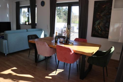 a dining room with a wooden table and chairs at Ferienwohnung Nalbach Wohnung 1 in Nalbach