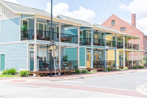 a blue and yellow house with balconies on a street at The Royal Crane Suite Newly Built Upscale Central in Gainesville