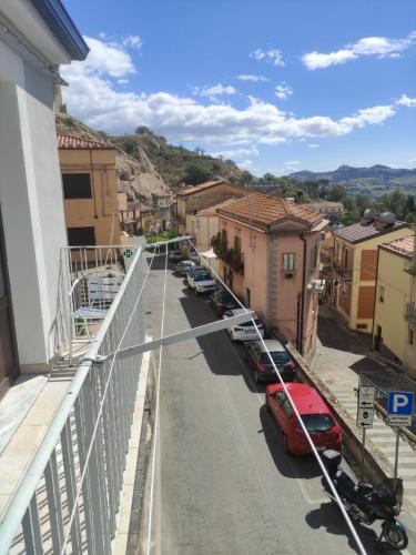 a street with cars parked on the side of a building at Al Municipio in Sperlinga