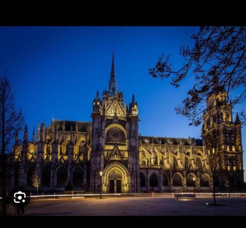 a large building is lit up at night at Evreux ground floor apartment,jardin,proche hyper centre in Évreux