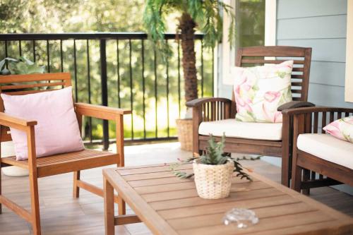 a porch with rocking chairs and a coffee table at The Lotus Suite Newly Built Upscale Central in Gainesville