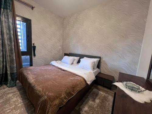 a bedroom with a bed with white sheets and pillows at Luxury Living - privado, Madinaty in Madinaty