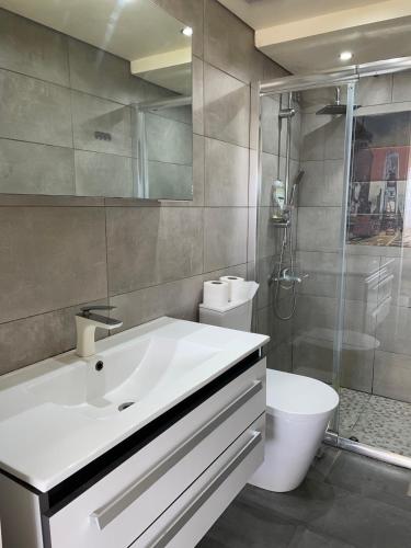 a bathroom with a sink and a shower and a toilet at wonderful duplex at Solemar resort Kaslik-Jounieh in Jounieh