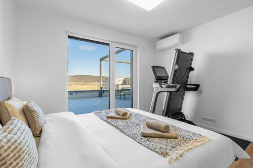 a bedroom with a bed with towels on it at BNB Panorama Bory Penthouse in Bratislava