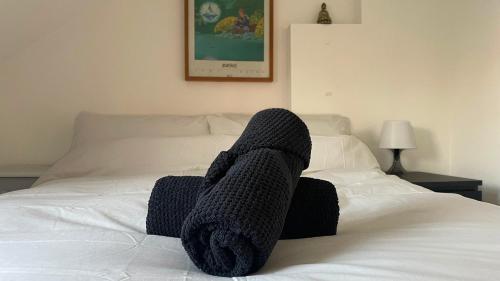 a person with their feet up on a bed at Bright & Spacious 2-Bed Townhouse in Waterford