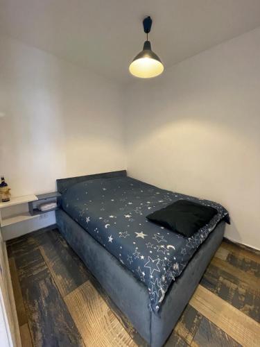 a bedroom with a bed in a room with a lamp at Renovated apartment Generator is included beach in Jounieh