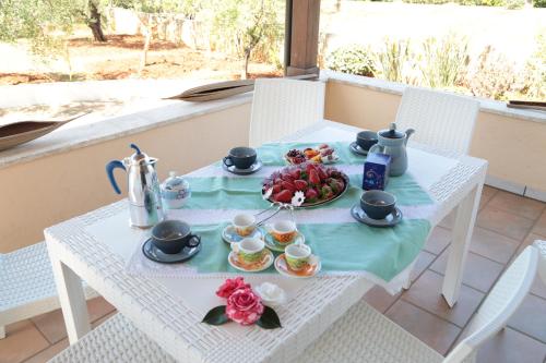 a white table with a tray of fruit on it at Villa Mele in Lido Marini
