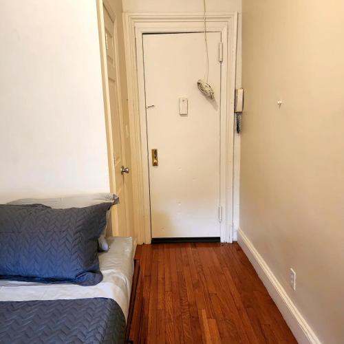 a bedroom with a bed and a white door at New York City GuestHouse in New York