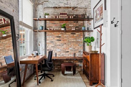 an office with a brick wall and a desk at Downtown Free Parking Garage - 5 min walk OTR in Cincinnati