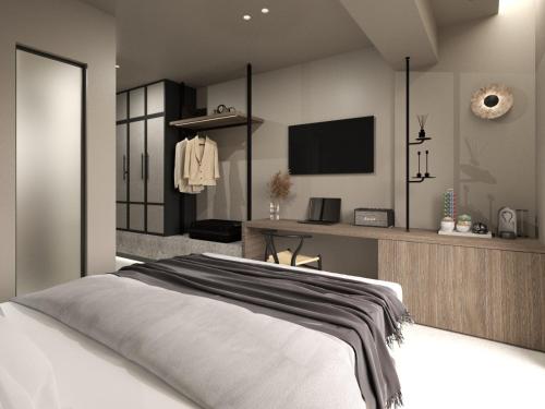 a bedroom with a bed and a tv in it at Scarabeo Suites & Villas Parga in Parga