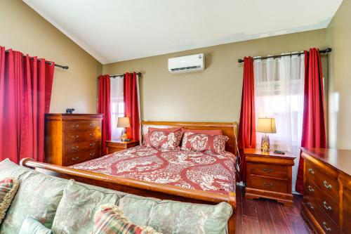 a bedroom with a bed and red curtains at 3 Mi Beech Mtn Resort: Cozy Studio w/ Deck & View! in Beech Mountain