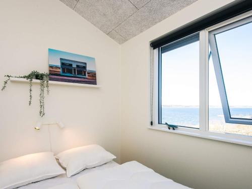 a bedroom with a bed and a window at 5 star holiday home in Løgstrup in Løgstrup