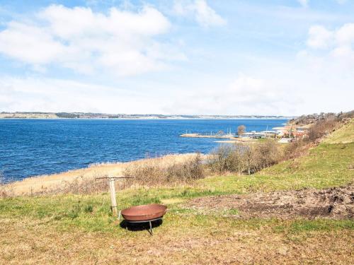 a boat sitting on a hill next to a body of water at 5 star holiday home in Løgstrup in Løgstrup