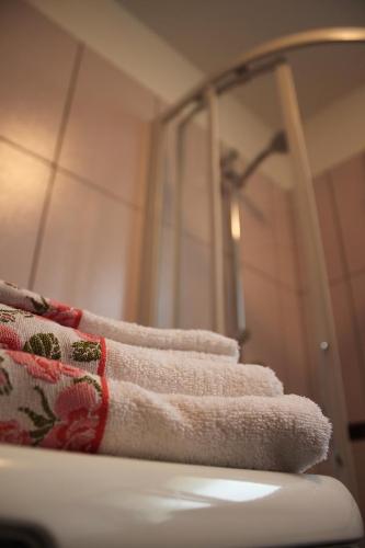 uma pilha de toalhas sentadas em cima de um lavatório de casa de banho em Studio 1 1/2 em Contone