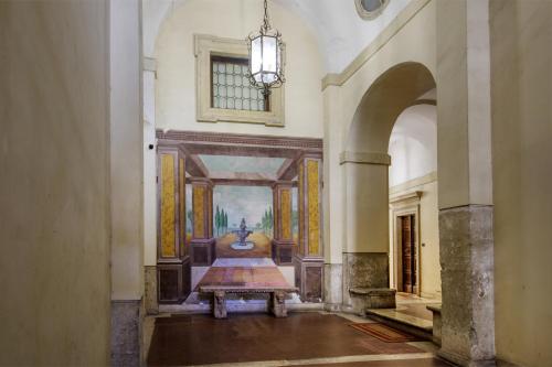 a hallway with a painting on the wall and a table at Navona Sky Palace in Rome