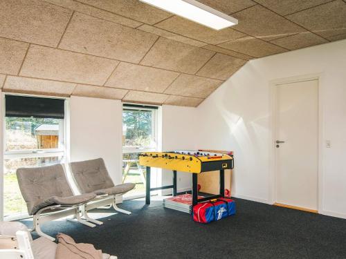 a room with a ping pong table and chairs at Luxury Retreat in Vorupor - By Traum Ferienwohnungen in Snedsted