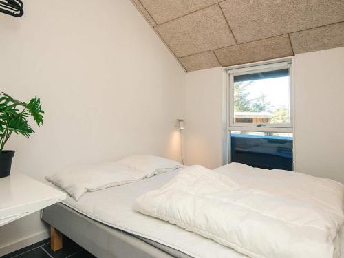a white bed in a room with a window at Luxury Retreat in Vorupor - By Traum Ferienwohnungen in Snedsted
