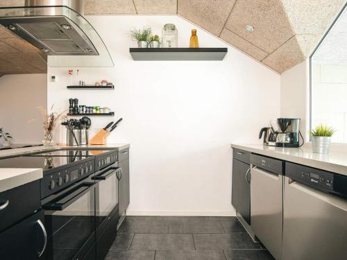 a kitchen with black appliances and white walls at Luxury Retreat in Vorupor - By Traum Ferienwohnungen in Snedsted