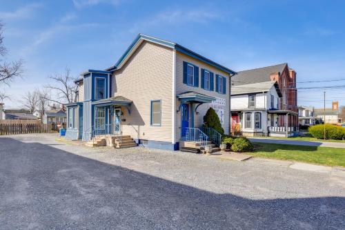 a white house with blue trim on a street at 1 Block to Dtwn Seneca Falls Apartment with Yard! in Seneca Falls