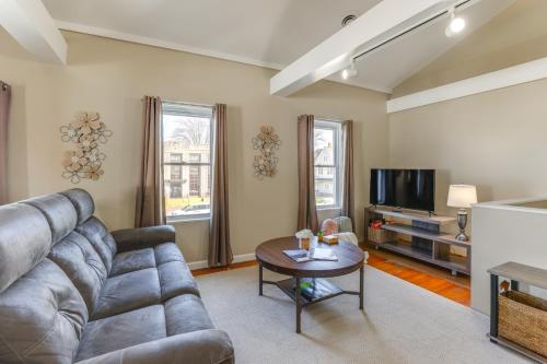 a living room with a couch and a tv at 1 Block to Dtwn Seneca Falls Apartment with Yard! in Seneca Falls