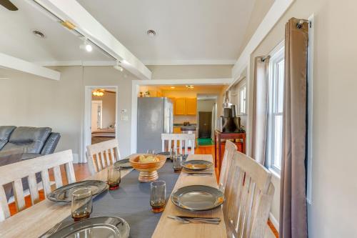 a dining room with a table with plates and silverware at 1 Block to Dtwn Seneca Falls Apartment with Yard! in Seneca Falls