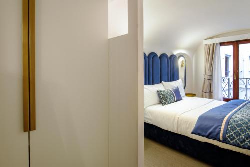 a bedroom with a bed with a blue headboard at Navona Sky Palace in Rome