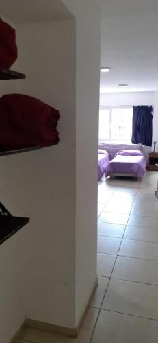 a room with white walls and a room with purple pillows at Centro in Neuquén