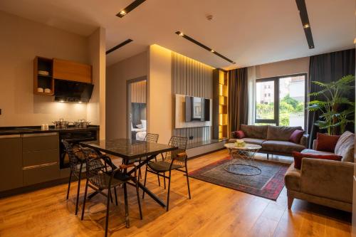 a kitchen and a living room with a table and chairs at TRAY TRABZON in Yomra