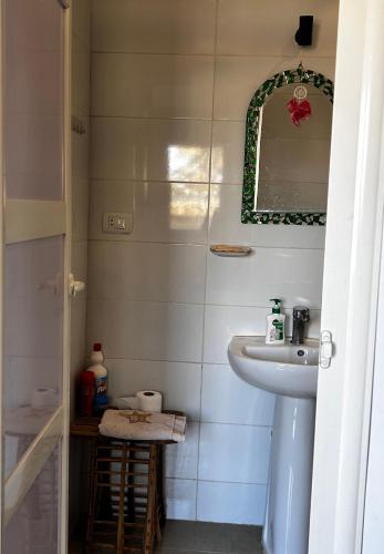 a bathroom with a sink and a mirror at Bedoune House-Light House in Dahab