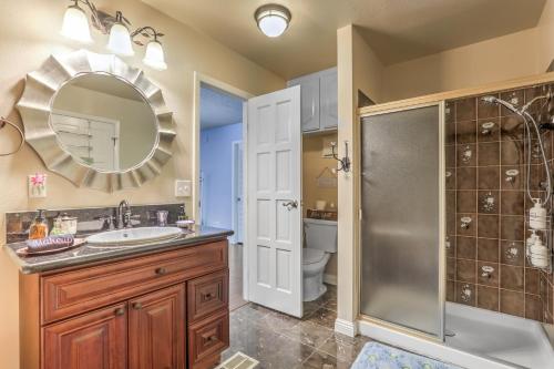 a bathroom with a sink and a shower and a mirror at The Oasis At The Lakes in Las Vegas