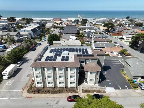 an aerial view of a building with solar panels on its roof at PACIFIC DRIFT San Francisco Pacifica in Pacifica