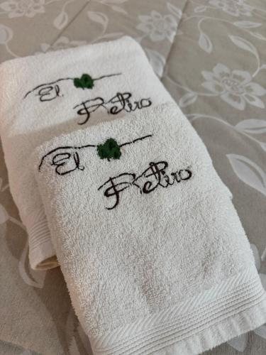 a close up of two towels on a bed at Retiro Gastro-Rural - Habitaciones in Moratalla