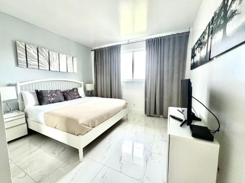 a bedroom with a bed and a television in it at Modern Apartments Ocean Reserve Sunny Isles Beach in Sunny Isles Beach