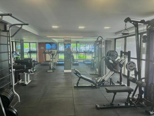 a gym with treadmills and machines in a room at Viva o Paraíso – Condomínio Exclusivo Beira-Mar e Lazer Completo in Ilha da Restinga