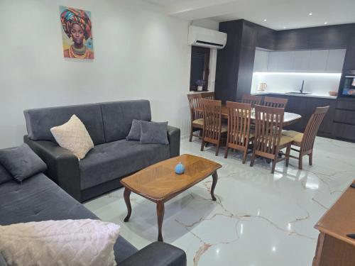 a living room with a couch and a table at Apartmani Mikić in Bosanski Šamac