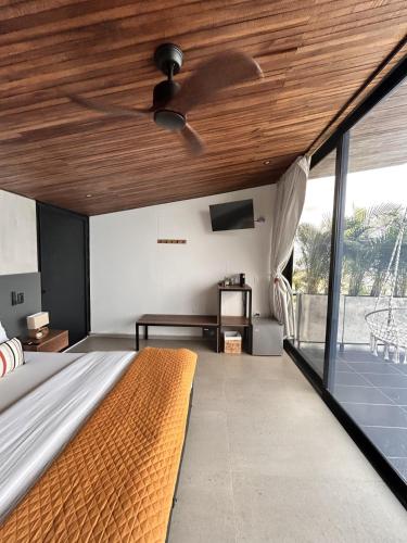 a bedroom with a bed with a wooden ceiling at Hotel Boutique el Fique in Los Santos