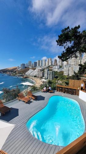 a swimming pool on a deck with a view of the ocean at Maré Hotel Boutique in Viña del Mar