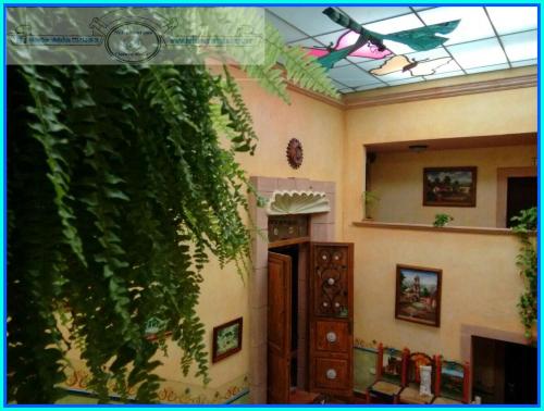 a room with a green ivy growing on the wall at Hotel Quinta Bella in Tula de Allende