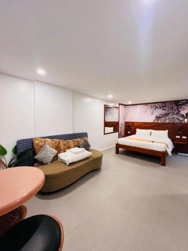a living room with a couch and a bed at Treasure Island Beach Resort in Olongapo