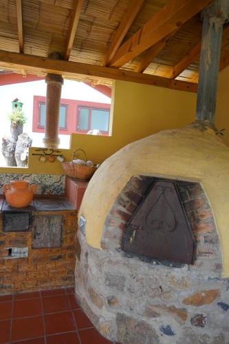 a large stone oven in a room with at Hotel Campestre Casa La María in Firavitoba
