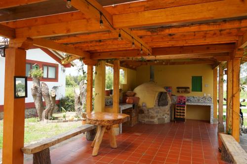 an outdoor kitchen with a pizza oven in a house at Hotel Campestre Casa La María in Firavitoba