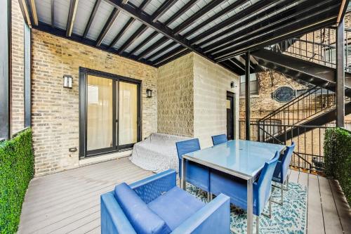a patio with a blue table and chairs at Luxurious Lincoln Park Home with Gourmet Kitchen in Chicago