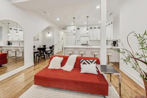a living room and kitchen with a red couch at Luxurious Lincoln Park Home with Gourmet Kitchen in Chicago