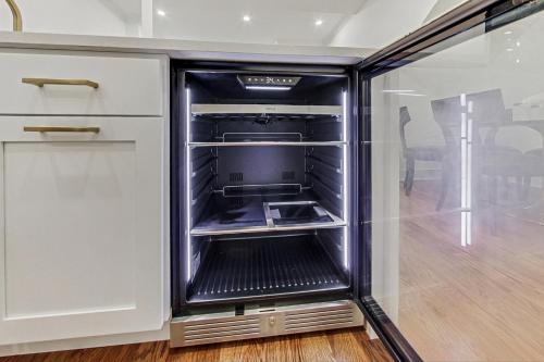 an empty refrigerator with its door open in a kitchen at Luxurious Lincoln Park Home with Gourmet Kitchen in Chicago