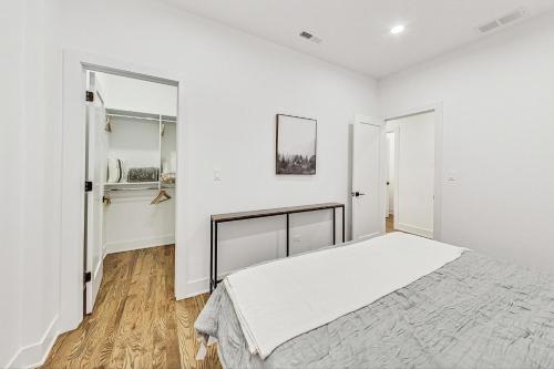 a white bedroom with a bed and a closet at Luxurious Lincoln Park Home with Gourmet Kitchen in Chicago