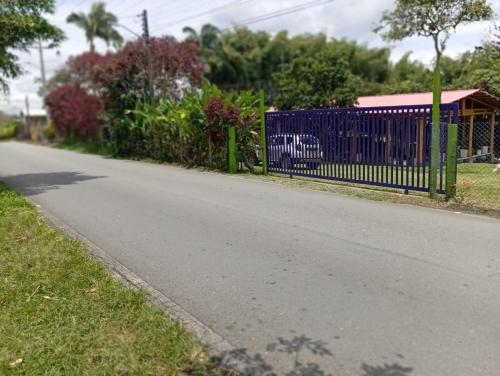 a blue fence on the side of a road at Finca Hostal La Esperanza in Quimbaya